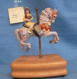 Girl with Teddy bear on A Carousel Horse